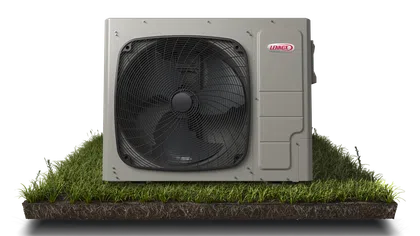 Lennox outdoor HVAC unit on grass with visible fan and logo, isolated on white background