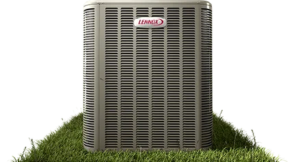 Lennox air conditioning unit installed on a grass-covered soil patch, isolated background.