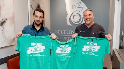 Two men holding green shirts that say Missing 100+ pounds, promoting weight loss success at Beltline clinic.