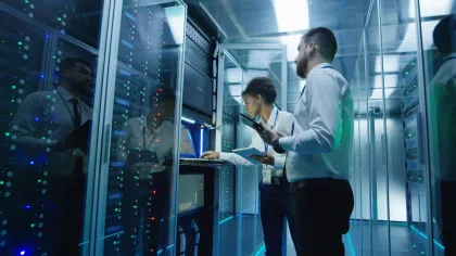 a man and woman working in a server room