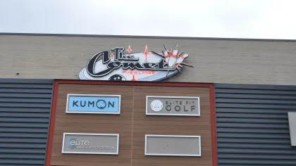 Storefront signs for Kumon, Elite Fit Golf, Elite Radiology of Georgia, and The Comet Pub & Lanes on a commercial building.