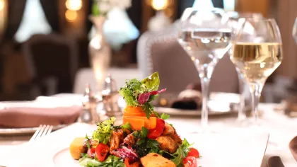a plate of food and wine glasses