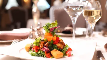 a plate of food and wine glasses