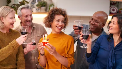 a group of people holding wine glasses