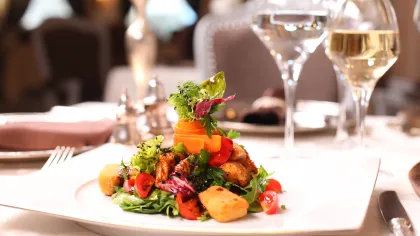 a plate of food and wine glasses