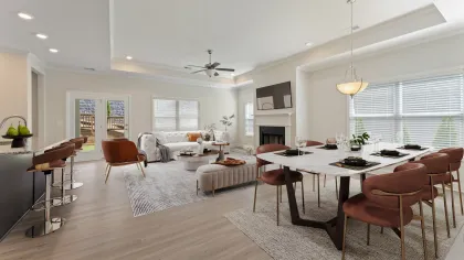 a large living room with a dining table and chairs