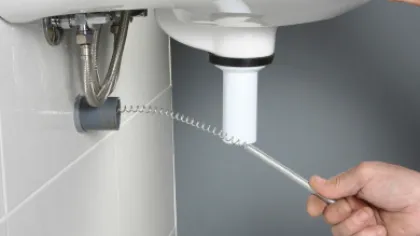 a drain being cleaned professionally