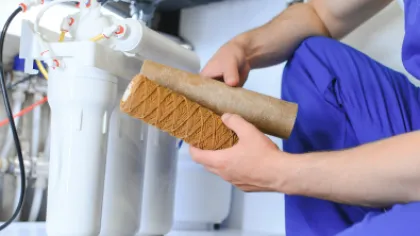 a plumber fixing a water filtration system
