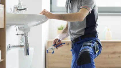 a plumber fixing a sink pipe