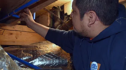 Estes Services plumber repairing a water leak in a crawl space