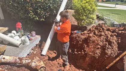 Estes Services plumber installing an underground sewer line during residential sewer line replacement.