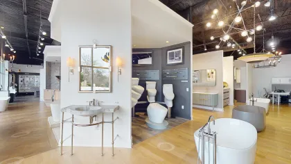 Modern showroom featuring elegant bathroom fixtures and chic lighting in a spacious design.