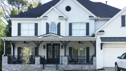 a white house with a green lawn