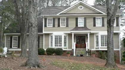 a house with a porch and a light post