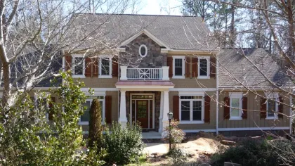 a large brick house with a large front yard