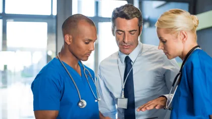 a few doctors looking at a tablet