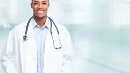 a doctor smiling with a stethoscope around his neck