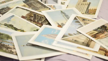 Collection of vintage postcards with cityscapes and landmarks spread on a surface.