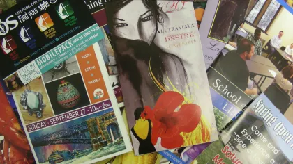 Collection of colorful promotional flyers and posters featuring events, art, and community activities.