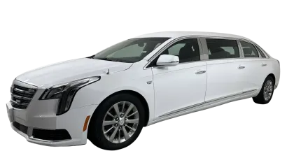 White luxury extended limousine with sleek design and tinted windows isolated on black background.
