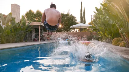 a person jumping into a pool