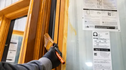 a person's hand holding a door handle