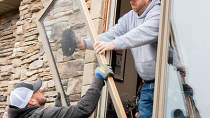 a man painting a window