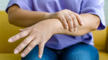 a close-up of a person holding their hands together