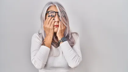 a woman with her hands on her face