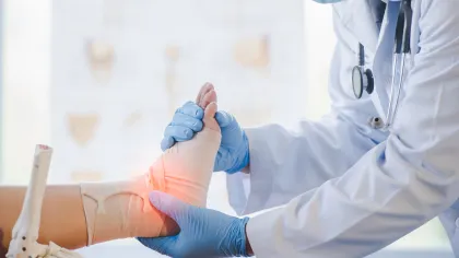 a doctor holding a patients ankle