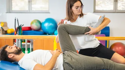 a woman holding a man's belly