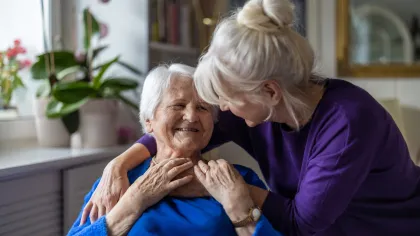 a woman holding an older woman