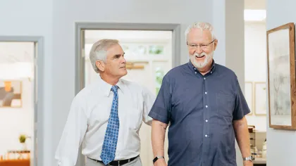 a couple of men standing in a room
