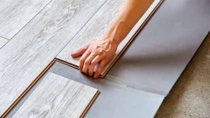 a hand holding a piece of wood