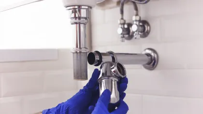 a person holding a faucet