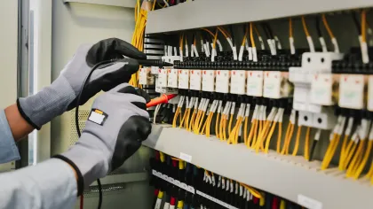 a person wearing gloves and gloves working on a computer