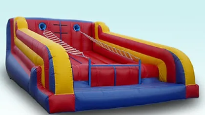 Colorful inflatable climbing and sliding obstacle course with ladders and barriers for outdoor fun.