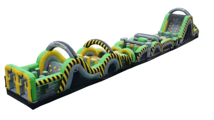 Long inflatable obstacle course with green, yellow, and black sections featuring climbing walls and tunnels.
