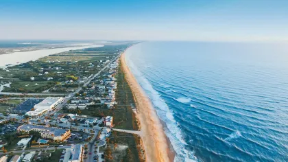 a beach with buildings and water