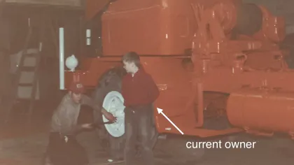 a group of men standing next to a large truck