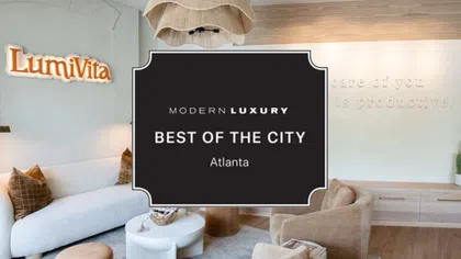 Modern luxury living room with beige chairs, white sofa, wooden flooring, and Lumivita sign on wall in Atlanta.