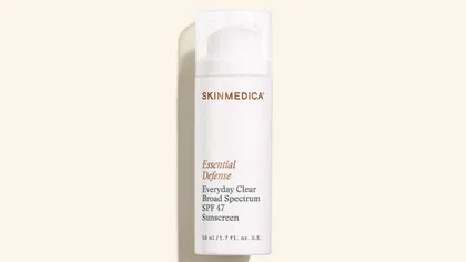 SkinMedica Essential Defense Everyday Clear Broad Spectrum SPF 47 sunscreen bottle on beige background.