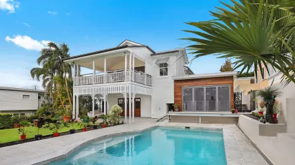 a large white house with a pool