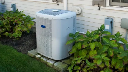 a couple of lawn chairs sitting on top of a refrigerator
