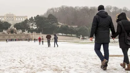 a man and woman walking in the snow