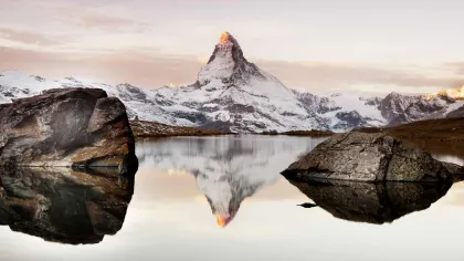 a body of water with mountains in the background