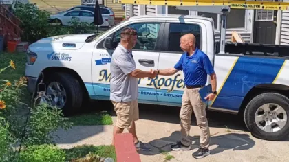 Master Roofers shaking hands with a satisfied roofing customer