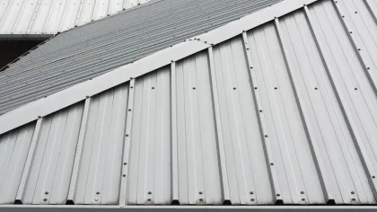 Close-up of a corrugated metal roof showcasing diagonal layering and texture.