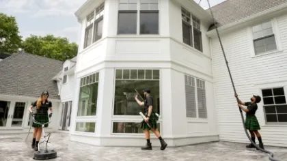 a group of people dancing outside a house