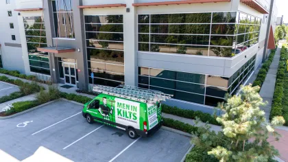 a green truck parked in front of a building